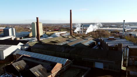 Pilkington-glass-factory-warehouse-buildings-aerial-rising-view-overlooking-industrial-town-manufacturing-facility