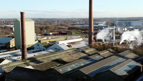 Pilkington-glass-factory-warehouse-buildings-aerial-view-descends-to-industrial-town-facility