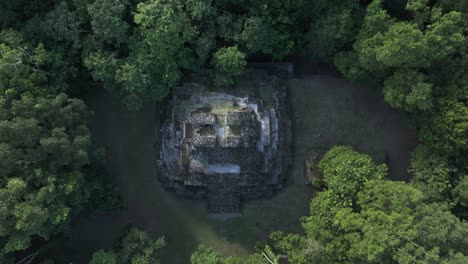Flying-towards-mayan-pyramid-at-Yaxha-Tikal-national-park,-aerial