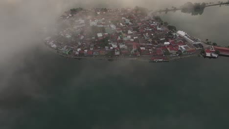 Reveal-shot-of-Isla-De-Flores-Guatemala-during-sunrise,-aerial