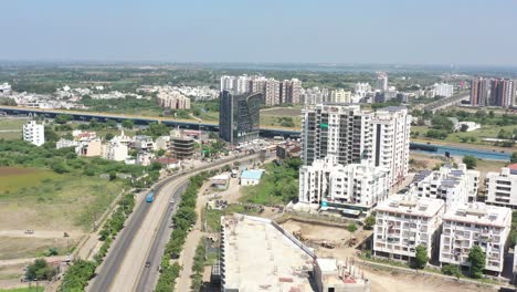 RAJKOT-CITY-AERIAL-VIEW-CAMERA-GOING-AHEAD-OF-MADHAPAR-CHOWKDI-WHICH-IS-COVERED-BY-MANY-TREES