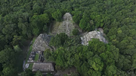 Reveal-shot-of-Yaxha-North-Acropolis-maya-ruins-at-Guatemala,-aerial