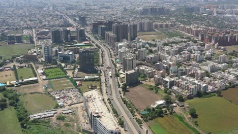 RAJKOT-CITY-AERIAL-VIEW-DRONE-CAMERA-GOING-AHEAD-CONSTRUCTION-COMPLEX-IS-WORKING-ON-WITH-MANY-FOURWHEELERS-PARKED-BESIDE-IT