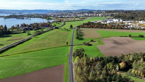 Aerial-view-of-great-landscape-and-highway-with-view-of-Zurich-lake-near-Bollingen,-Switzerland