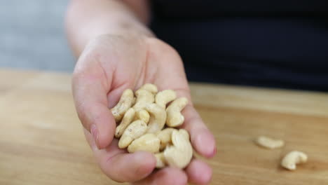 An-unrecognizable-female-holding-cashews