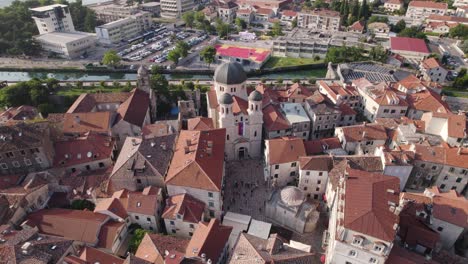 Aerial-wide-view-of-Saint-nicholas-Church-in-Kotor-old-town,-circling-shot