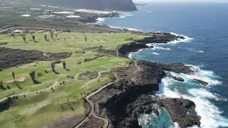 Panoramic-aerial-parallax-of-stunning-golf-course-on-edge-of-rocky-ocean-cliff-in-Tenerife
