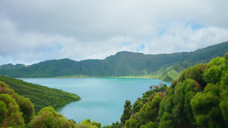 walking-through-green-lush-vegetation-viewpoint-unveiling-the-picturesque-volcanic-lake-in-the-Azores