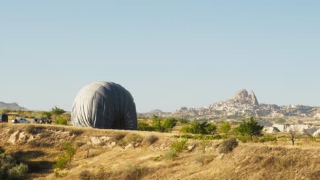 Hot-air-balloon-deflates-scenic-morning-landscape-Uchisar