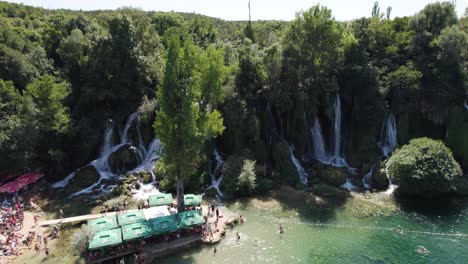 Summer-day-at-Kravica-Waterfall-with-tourists,-Bosnia