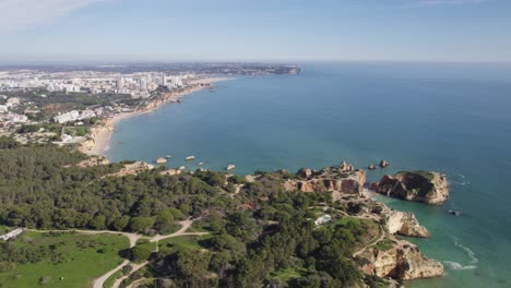 Lush-Green-Portimão-Cliffs-Over-Azure-Sea,-Algarve-Portugal---Aerial