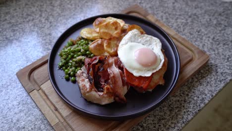 Plate-Of-Costillas-A-La-Riojana-With-Fried-Bacon,-Egg,-Peas-And-Potato-Chips