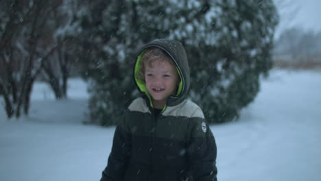 Happy-kid-on-Christmas-morning-playing-in-snow