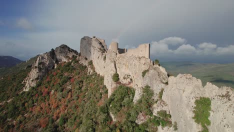 Aerial-revealing-shot-of-the-Peyrepertuse-castle-ruins-in-France-during-autumn