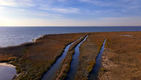 A-low-altitude,-aerial-view-over-a-salt-marsh-on-the-south-shore-of-Long-Island,-New-York-on-a-sunny-day