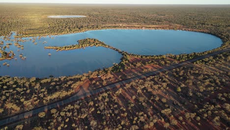 Aerial-approaching-shot-of-lake-in-semi-desert-area-of-Western-Australia-at-sunset-time