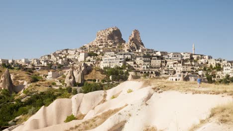 Woman-views-Uchisar-rocky-landscape-holiday-destination-Cappadocia