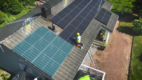 Engineer-testing-and-adjusting-solar-panels-on-a-house-roof---CGI-render