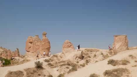 Tourists-visit-amazing-natural-erosion-rock-formation-scenic-landscape