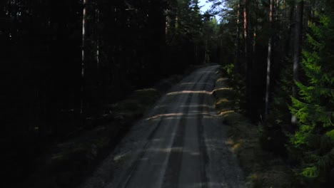 Drone-shot-from-an-empty-gravel-road-in-the-forest-in-Sweden
