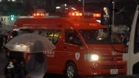 Emergency-Fire-Truck-Ambulance-on-Shibuya-Crossing-at-Night,-Tokyo,-Japan