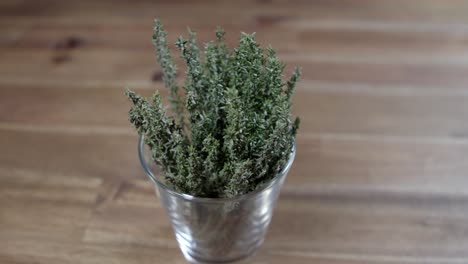 Fresh-thyme-branches-in-a-small-glass-container,-essential-ingredient-for-the-preparation-of-argentine-chimichurri