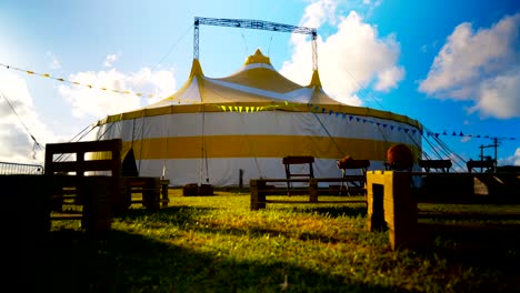 Colourful-circus-tent-with-racing-clouds-behind-cinematic-timelapse