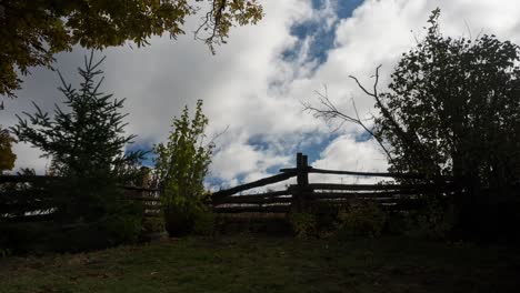 Dramatic-Clouds-Moving-Over-A-Rural-Fence,-landscape-Timelapse