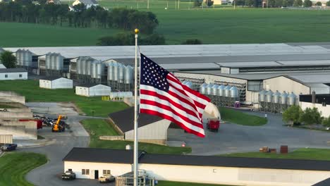American-flag-waving-at-large-factory-farm-in-USA