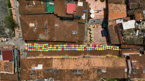 Aerial-top-down-shot-above-a-umbrella-street-in-the-Guatape-Town,-sunny-Colombia
