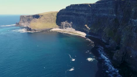 A-drone-shot-of-the-Cliffs-of-Moher,-the-tallest-sea-cliffs-of-the-rugged-West-Clare-Coast-of-Ireland
