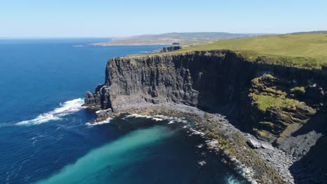 A-drone-shot-of-the-Cliffs-of-Moher,-the-tallest-sea-cliffs-of-the-rugged-West-Clare-Coast-of-Ireland