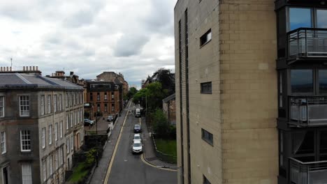 Aerial-4K-close-up-of-Glasgow-high-end-new-apartment-building-neighbourhood,-Scotland-United-Kingdom