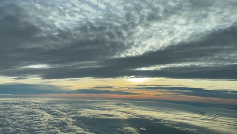 Awesome-clouded-sky-at-sunset,-shot-at-the-golden-minute-from-a-jet-cabin-flying-westbound-at-4000m-high-near-Valencia,-Spain