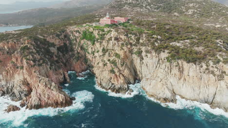 Faro-di-Capo-Spartivento,-Sardinia:-wonderful-aerial-view-over-the-coast-and-the-beautiful-lighthouse-converted-into-a-hotel