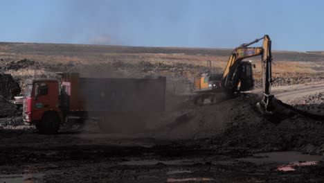 Excavator-Loading-Iron-Ore-Into-Dump-Truck