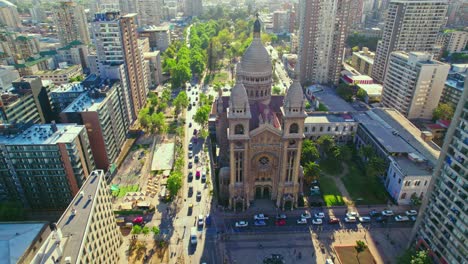 Aerial-orbit-establishing-of-Los-Sacramentinos-Church-on-a-sunny-day-with-heavy-traffic-in-Santiago-Chile