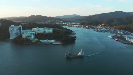 Toba-Bay,-Aerial-View-Revealing-Hotels-and-Ship-Heading-to-Sea-in-Japan