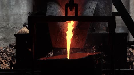 POV-SHOT-of-iron-being-melted-in-a-high-degree-Celsius-furnace-and-exiting