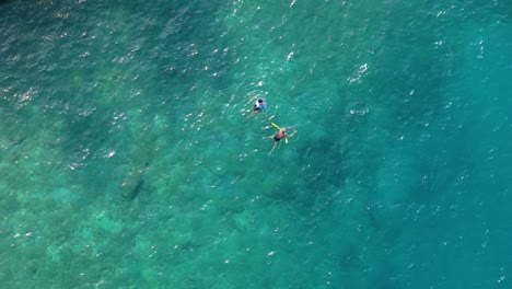 Swimmers-play-in-clear-blue-Caribbean-ocean-waters-of-Zanzibar-beach-Jan-Thiel-Curacao