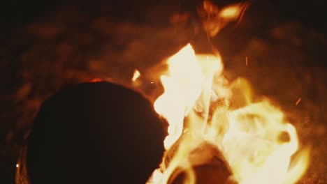 Closeup-shot-of-flames-rising-up-from-blazing-bonfire-in-desert,-slow-motion