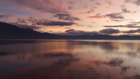 Amazing-colours-at-sunrise-on-Lake-Atitlan-Guatemala,-aerial