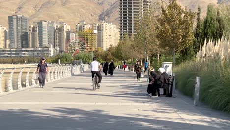 People-are-spend-time-in-central-park-New-York-Tehran-Tokyo-side-lake-city-center-early-morning-fresh-weather-blue-sunny-sky-in-summer-cycling-walking-women-life-and-building-tower-urban-life