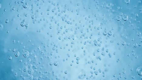 Oxygen-bubbles-in-water-on-a-blue-abstract-background-on-super-slow-motion.