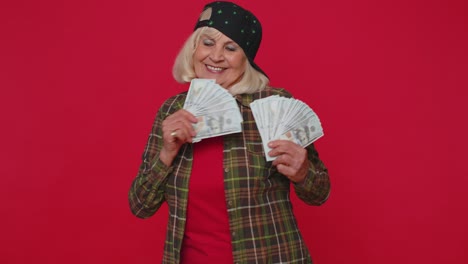 Rich-pleased-boss-senior-woman-waving-money-dollar-cash-banknotes-like-a-fan-success-business-career