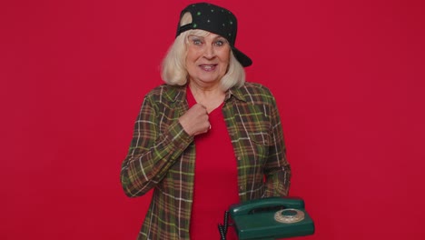 Cheerful-tourist-woman-secretary-talking-on-wired-vintage-telephone-of-80s,-say-Hey-You-Call-Me-Back
