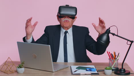 Senior-businessman-using-headset-helmet-app-to-play-simulation-game,-watching-virtual-reality-video