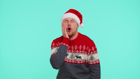 Man-wears-red-New-Year-sweater-deer-raising-hands-in-surprise-shocked-by-sudden-victory,-wow-emotion