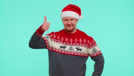 Funny-man-wears-red-New-Year-sweater-raises-thumbs-up-agrees-something-good,-like,-blue-background