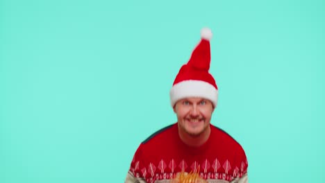 Fröhlicher-Mann-Im-Weihnachtspullover-Präsentiert-Eine-Weihnachtsgeschenkbox-Und-Streckt-Seine-Hände-In-Die-Kamera
